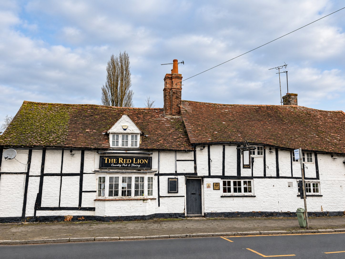 Timber-framed Red Lion pub with an old clay tile roof