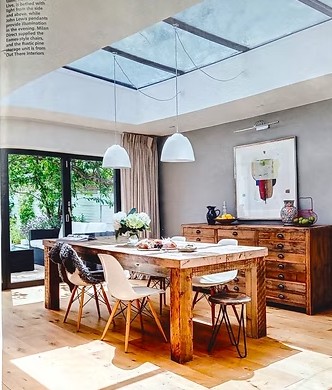 Magazine feature showing a Battram kitchen and dining room under a large roof light