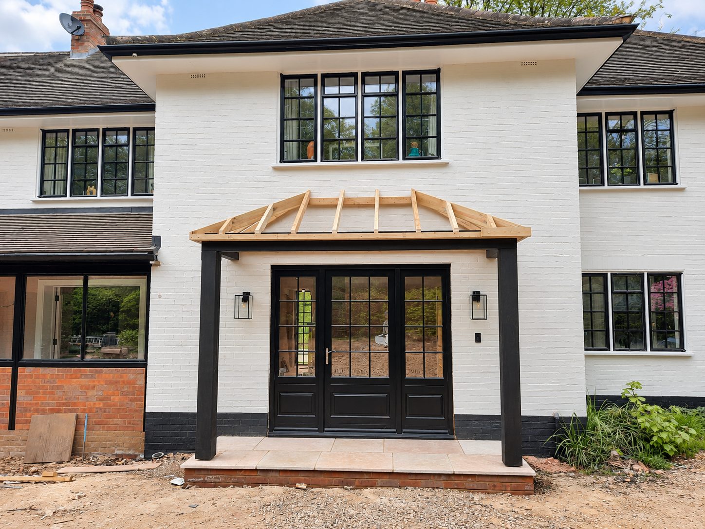 Painted brick house with new black timber porch posts and glazed double front doors