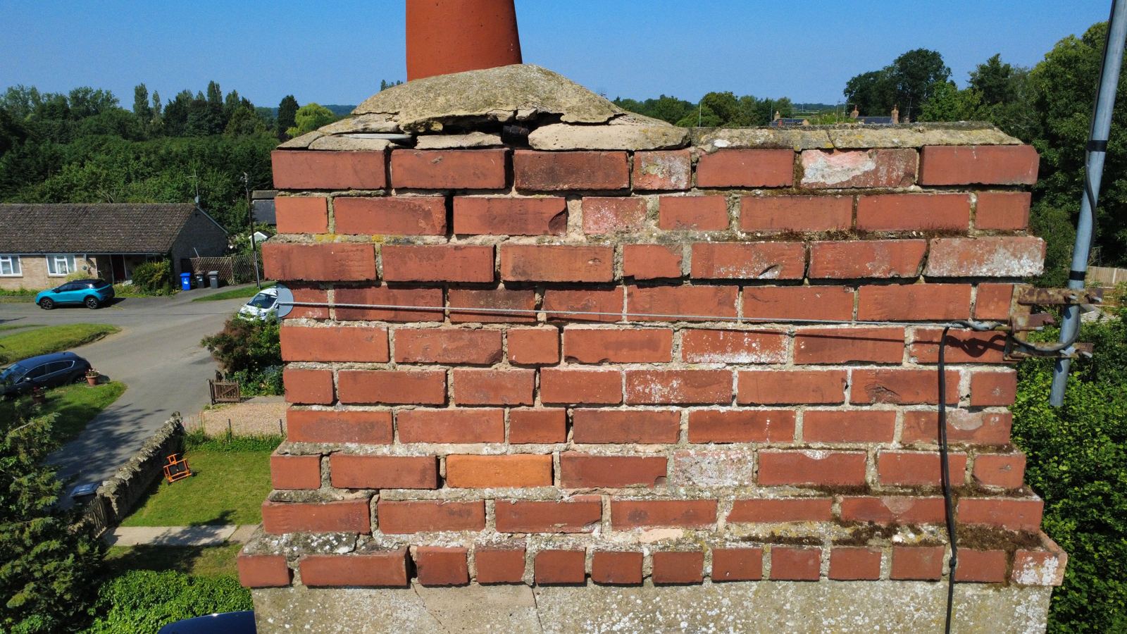 Chimney brickwork with eroded joints and a cracked, displaced flaunching, photo 4 of 4