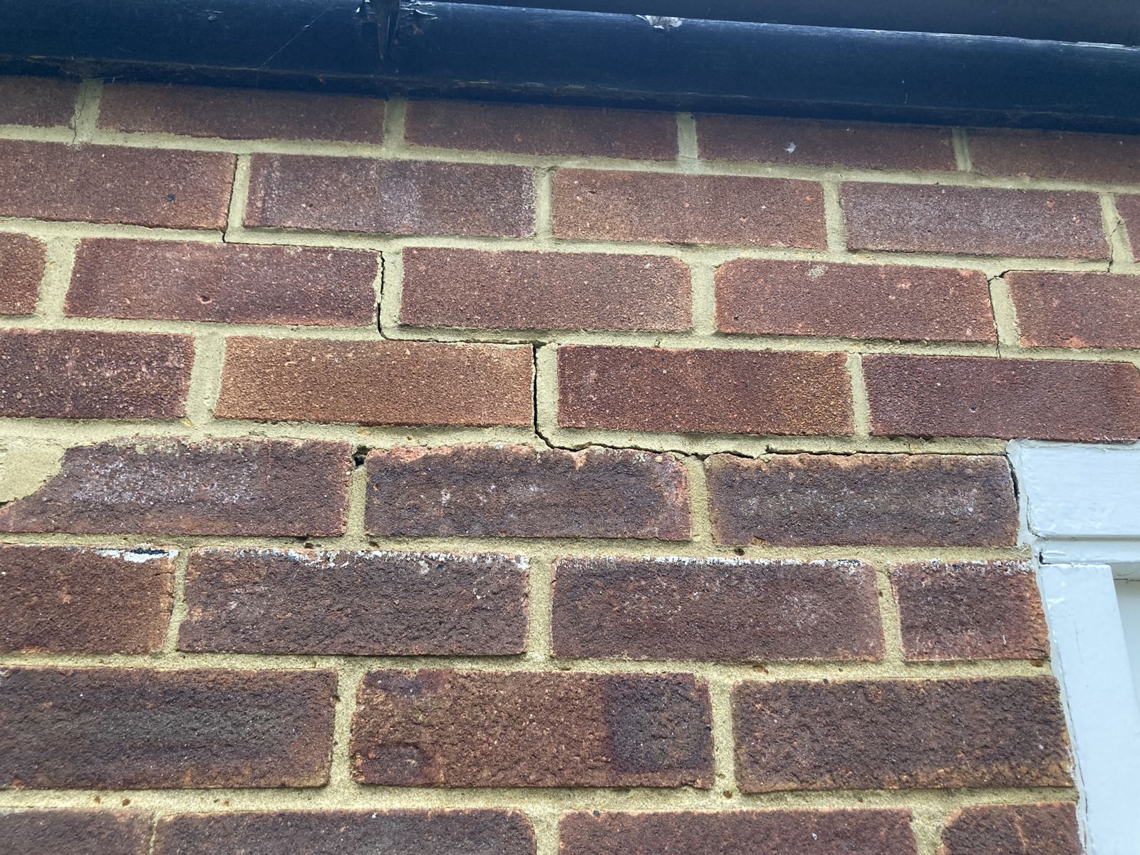 Stepped crack running through the brickwork below the gutter, photo 2 of 2
