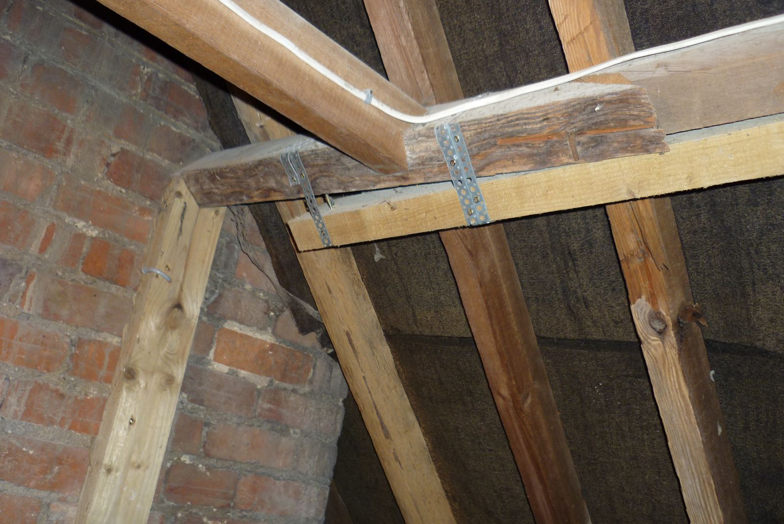 Roof timbers with a sistered ceiling tie fixed with metal straps beside the chimney breast, photo 2 of 2