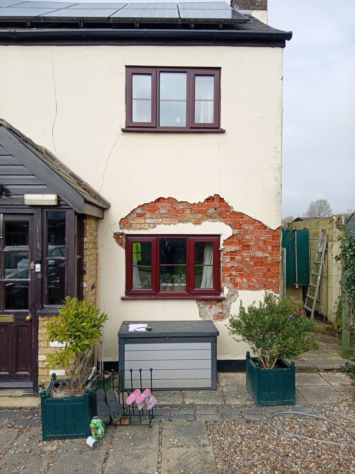 Front elevation with patches of render removed, photo 1 of 4