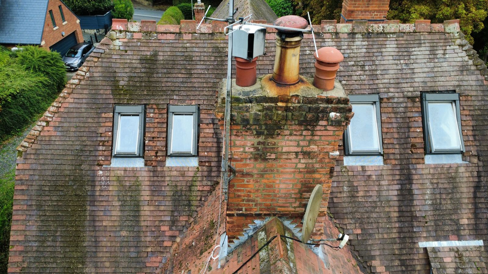 Drone view of a clay tiled roof with chimney and dormers, photo 1 of 1